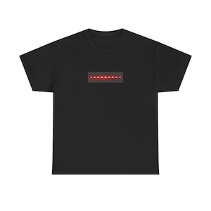 May include: Black t-shirt featuring a rectangular design with a series of red dots. The design is centered on the chest area of the shirt. The t-shirt is made of a soft material.