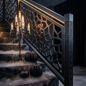 May include: A black staircase with marble steps and a geometric metal railing featuring integrated lighting. A black metal candelabra with white candles stands on the stairs alongside three black pumpkins, all surrounded by low-lying white fog.