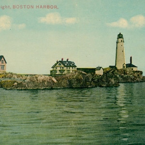 May include: Vintage postcard featuring Boston Light, Boston Harbor. The image shows a tall, white lighthouse on a rocky island, with several buildings and the calm water of the harbor. The sky is a light blue with a few clouds.