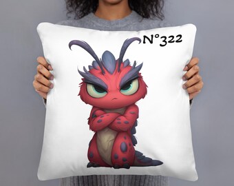 May include: White throw pillow featuring a cartoon illustration of a red and blue monster with crossed arms and a stern expression. The pillow has the text "N°322" in black.