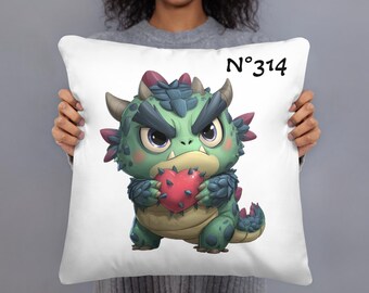 May include: White square pillow featuring a cartoon dragon holding a red heart. The dragon is green, blue, and tan with a stern expression. The text "N°314" is printed in black in the upper right corner.