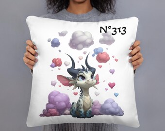 May include: White decorative pillow featuring a cartoon dragon with blue and white scales, black horns, and pink ears. The design includes colorful clouds, hearts, and the number "313".
