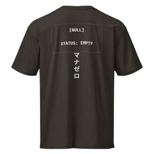 May include: Dark brown t-shirt with the text "[NULL] STATUS: EMPTY" in a white, glitch-style font. Japanese characters are printed vertically below the text. The shirt has short sleeves and a crew neck.