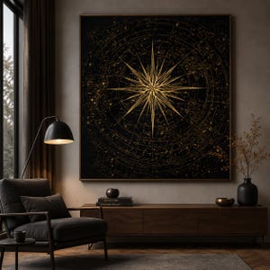 May include: A large square wall art piece featuring a central gold starburst design against a black background, surrounded by concentric circular lines and intricate celestial patterns that resemble a vintage star map or navigation compass.