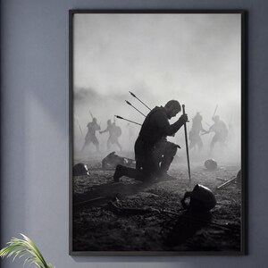 May include: A black and white wall art print depicting a lone warrior kneeling on a battlefield, leaning on a sword with arrows protruding from their back. In the misty background, silhouettes of other figures are visible amidst the debris.