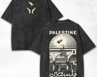May include: Dark gray t-shirt with a distressed finish. The front features a graphic of a dove with the Palestinian flag and open hands. The back displays the word "PALESTINE" above a dome and flag illustration, with Arabic text below.