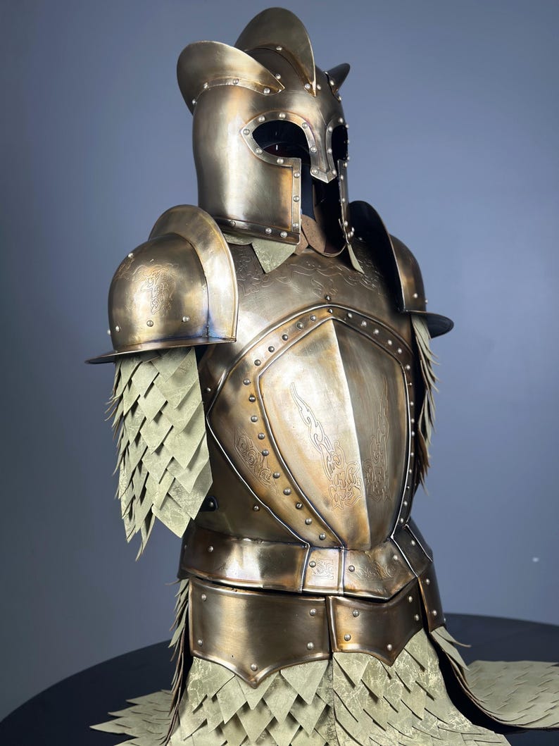 May include: A detailed bronze-colored suit of armor, featuring a helmet with eye openings and a decorative crest. The armor includes shoulder guards, a chest plate with embossed designs, and layered skirt-like elements. The overall design suggests a medieval or fantasy theme.