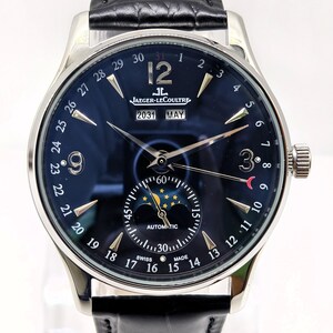 May include: A silver-tone automatic wristwatch with a dark blue dial, featuring a moon phase display, a date calendar with numbers 1 through 31, and a window showing 2031 and MAY. The watch has a black leather strap with a textured finish.