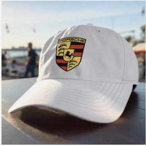 May include: A white ceramic mug with a black handle and the text "But First, Coffee" in a handwritten style. The mug is on a white surface. The mug is 4 inches tall.