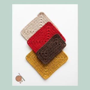 May include: Four crocheted square potholders in beige, red, brown, and mustard yellow are arranged diagonally. Each potholder has a decorative openwork pattern. A ball of yarn and a crochet hook are in the lower left corner.