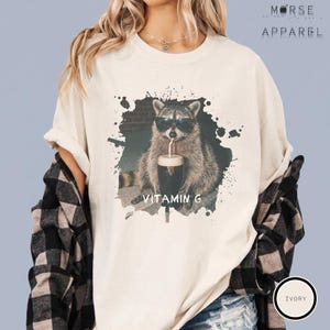 Funny Raccoon Drinking Beer Vitamin G T-Shirt, Comfort Colors® Guinness Tee, Pub Party Shirt, Unisex Trendy Meme Graphic Top Ivory