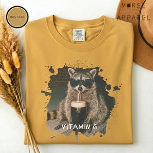 Funny Raccoon Drinking Beer Vitamin G T-Shirt, Comfort Colors® Guinness Tee, Pub Party Shirt, Unisex Trendy Meme Graphic Top Mustard