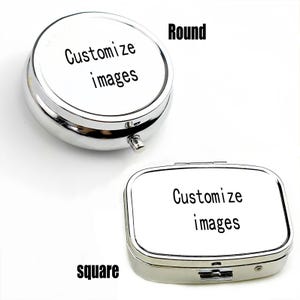 K&ouml;nnte beinhalten: Zwei silberne Pillendosen, eine runde und eine quadratische, werden gezeigt. Beide haben wei&szlig;e Deckel mit dem Text "Customize images" in Schwarz. Die runde Dose befindet sich oben, die quadratische unten.
