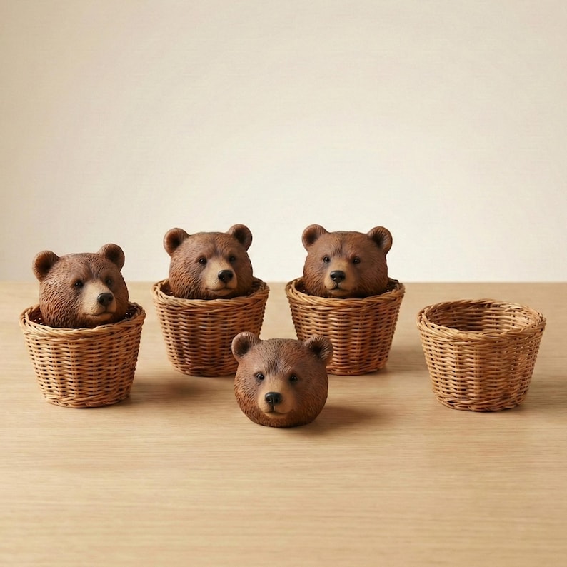 May include: Several brown bear heads are displayed, emerging from small, woven wicker baskets. One bear head is separate. The bears have detailed fur and realistic features. The baskets are light brown and have a woven texture.