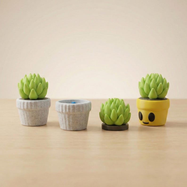 May include: Four small succulent plant figurines. Two are in grey pots, one is on a brown base, and one is in a yellow pot with a smiling face. The succulents are a bright green colour.