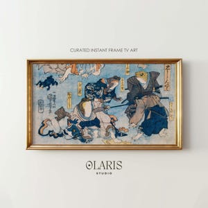 May include: A framed print of Japanese art featuring anthropomorphic frogs in traditional attire. The artwork, set against a light blue backdrop, showcases a dynamic scene with detailed figures and calligraphy. The frame is gold, and the print is labeled "CURATED INSTANT FRAME TV ART".