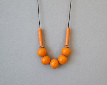 Orange ceramic necklace with round mate beads and adjustable length
