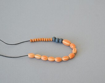 Orange and grey ceramic and wood necklace with adjustable length