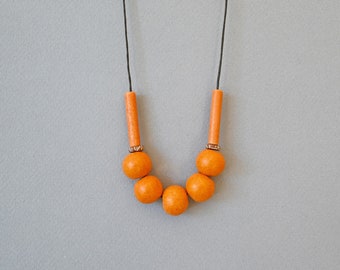 Orange ceramic necklace with round mate beads and adjustable length