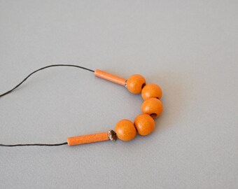 Orange ceramic necklace with round mate beads and adjustable length