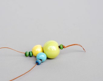 Bright ceramic necklace with round beads in green, yellow and blue.