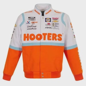 May include: White and orange racing jacket with the word "HOOTERS" in large orange letters across the chest. The jacket has blue accents and various sponsor logos, including "NAPA" and "UniFirst". The sleeves are orange with red cuffs.