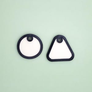 Könnte beinhalten: Ein Satz von drei Keramik-Nistbechern in Blau-, Grün- und Weißtönen. Die Schalen haben eine gesprenkelte Glasur und ein schlichtes, modernes Design. Die größte Schüssel hat einen Durchmesser von etwa 15 cm.