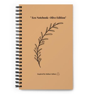 May include: A tan spiral-bound notebook featuring a black line drawing of an olive branch in the center. The text "Eco Notebook- Olive Edition" is printed at the top, and "Inspired by Italian Culture" with a recycling symbol is at the bottom.