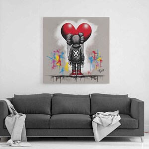 May Include: Urban street art canvas wall art featuring a graffiti-style character standing beneath a bold red heart, with X-marked details, paint drip effects, and colorful splashes on a neutral background, creating a modern love-themed wall decor ideal for a living room or bedroom.
