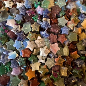 May include: A rustic wooden sign with the text "Welcome" in a handwritten style. The sign is painted white with a distressed finish, and features a decorative floral element in the corner. The background is a blurred image of a wooden surface.