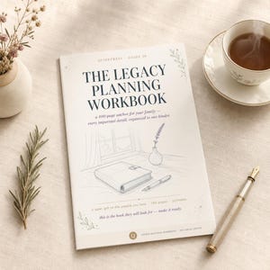 May include: A softcover "The Legacy Planning Workbook" book with a pen, teacup, and decorative vase. The book has a detailed illustration of a notebook and pen. The text reads "a 100-page anchor for your family".