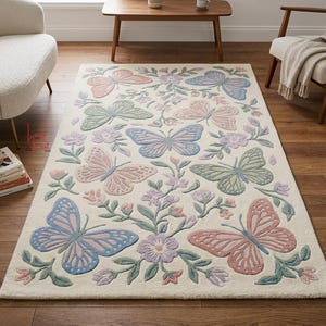 May include: A rectangular area rug with an off-white background featuring a repeating pattern of butterflies and floral sprigs in soft pastel shades of pink, blue, green, and lavender. The design is symmetrical with detailed wing textures.