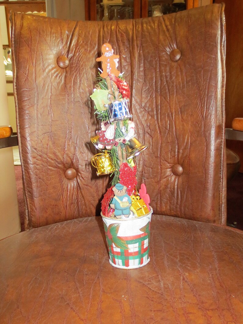 Child Decorated Charlie Brown artificial Christmas tree for image 0