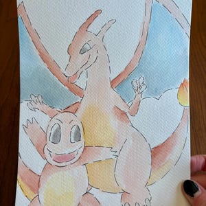 May include: Watercolor painting of two cartoon dragons, one larger and one smaller, in shades of orange, yellow, and pink. The larger dragon has outstretched wings and a flame on its tail. The background is light blue and white.