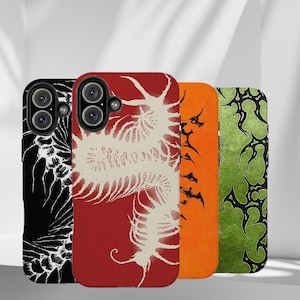 May include: Four rectangular phone cases featuring distinct graphic designs. The first is black with white skeletal patterns, the second is red with a large white centipede, the third is solid orange, and the fourth is green with black tribal-style art.