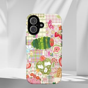 May include: A colorful phone case featuring a patchwork design with illustrations of a green caterpillar, strawberries, butterflies, and flowers. The case has a playful, whimsical aesthetic, with a mix of patterns and bright colors.