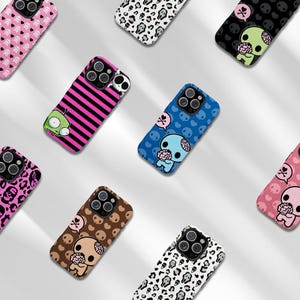 May include: A collection of phone cases with various designs. The cases feature cartoon characters, skulls, and patterns like stripes and leopard print. Colors include pink, black, blue, brown, and white. The cases are designed to fit a smartphone.