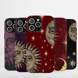 May include: A collection of five smartphone cases featuring celestial designs. Each case displays a vintage-style illustration of a sun or moon with human facial features, surrounded by gold-colored stars against backgrounds of purple, red, and black.