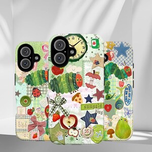 May include: Three colorful phone cases with whimsical designs. Each case features a patchwork style with illustrations of a caterpillar, apples, stars, and the text "snuggle hug". One case has a clock design. The cases are designed to fit a phone.