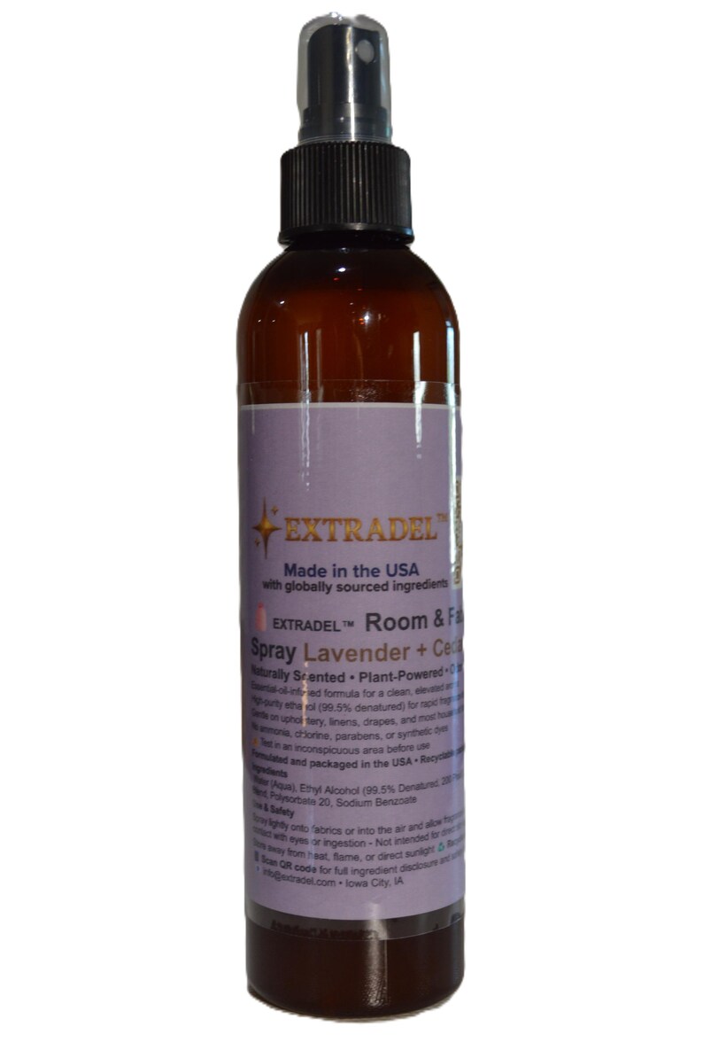 May include: A brown plastic spray bottle with a black nozzle and a label featuring the text EXTRADEL, Room & Fabric Spray, Lavender + Cedar. The label includes information about the plant-powered, naturally scented formula made in the USA.