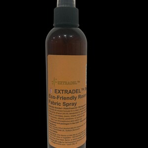 May include: A brown spray bottle with a black cap and a clear plastic cover. The label reads "EXTRADEL Eco-Friendly Room Fabric Spray". The bottle is designed for use on upholstery, linens, and drapes.