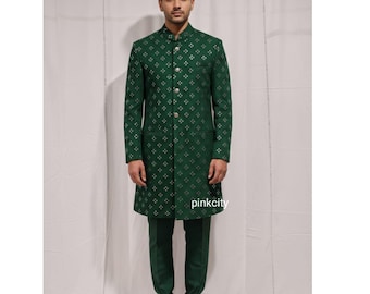 May include: A green suit with a patterned design. The suit includes a long coat with a mandarin collar and matching pants. The coat features a repeating silver floral pattern and silver buttons. The brand name "pinkcity" is visible on the coat.