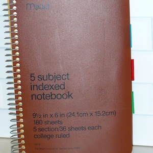 May include: Brown 5-subject indexed notebook with a spiral binding. The notebook is 9.5 x 6 inches and contains 180 sheets of college-ruled paper. Features colored index tabs and the Mead logo.