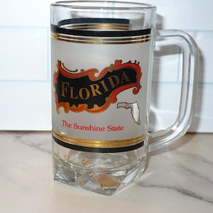 May include: A set of three ceramic mugs with a speckled, matte finish. The mugs are in shades of cream, light gray, and dark gray. Each mug has a simple, minimalist design, perfect for coffee or tea.