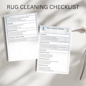 May include: Two white checklists titled "RUG CLEANING CHECKLIST" with black text. The checklists provide instructions for drying, deodorizing, regular maintenance, and professional cleaning of rugs. One checklist is slightly angled, and the other is in the background.