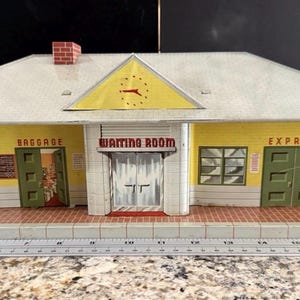 May include: A white ceramic mug with a black handle and the text "But First, Coffee" in a black, bold font. The mug is sitting on a wooden surface. The mug is approximately 4 inches tall.