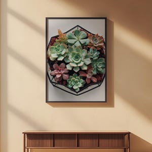 Succulent wall art poster displayed on a warm beige wall above a wooden desk with natural sunlight creating geometric shadow patterns