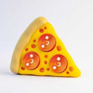 May include: A slice of pizza with yellow cheese, three pepperoni slices, and a crust with a wood grain pattern. The pepperoni has a spiral design with white dots. The pizza slice is on a white background.