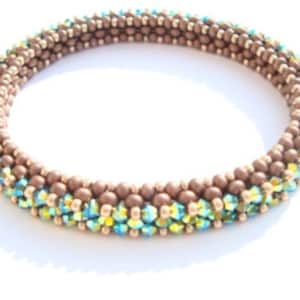 May include: A brown beaded bracelet with a row of iridescent green and gold beads.