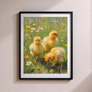 May include: A framed print depicting three yellow chicks amidst a meadow of wildflowers. The chicks, with their fluffy plumage, stand out against the green and floral background. The artwork is enclosed within a black frame, enhancing the image.